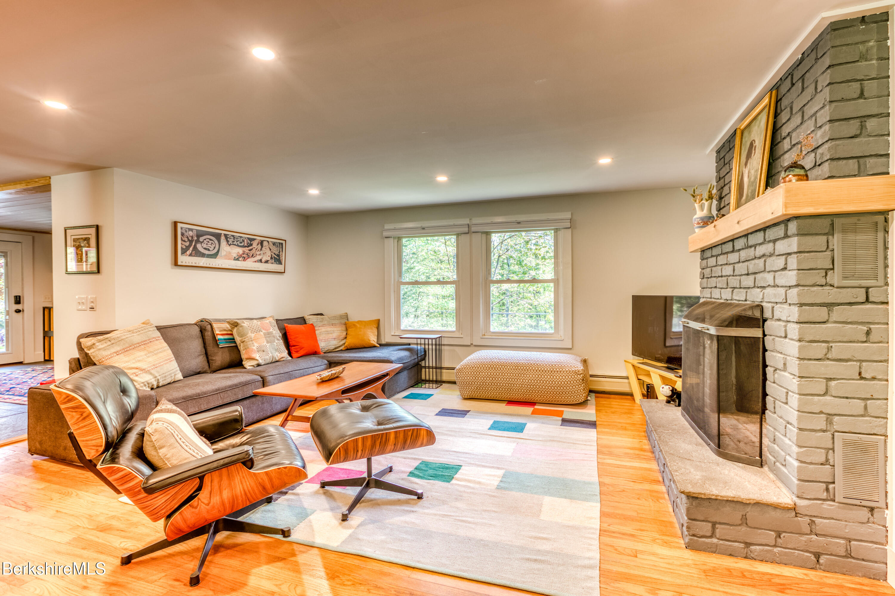 6 Lake Buel Road Great Barrington, MA 01230 - Photo 21 of 38 a living room with fireplace furniture and a flat screen tv