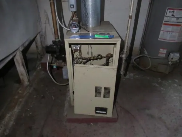 a room with water heater and white walls