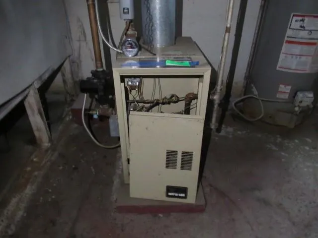 a room with water heater and white walls