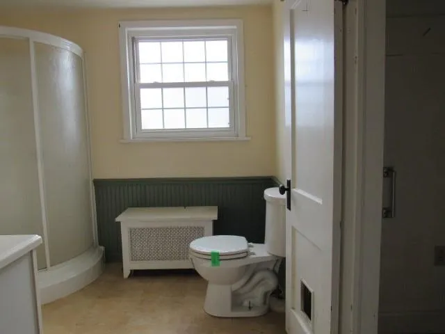 a bathroom with a sink toilet and a window