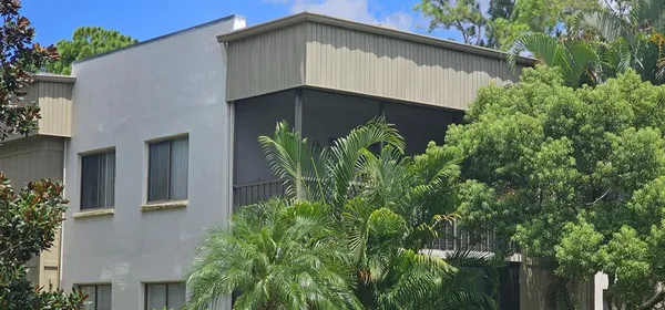 front view of a house with potted plants