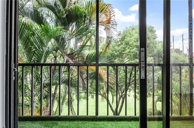 a view of a yard with large trees