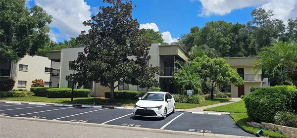 a view of a white house with a yard