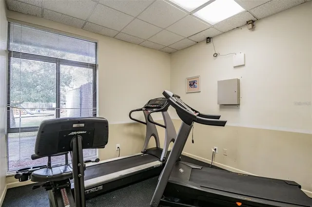 a room with gym equipment and windows