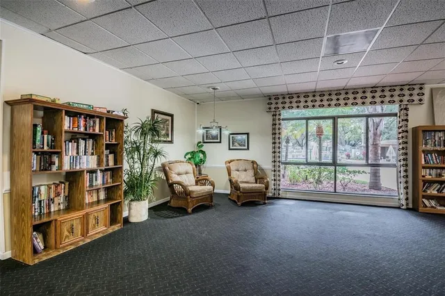 a very nice looking room with a large window and a book shelf