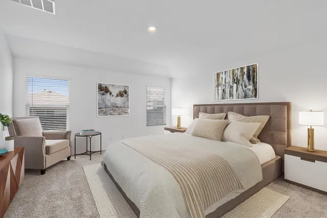 a bedroom with a bed and a couch