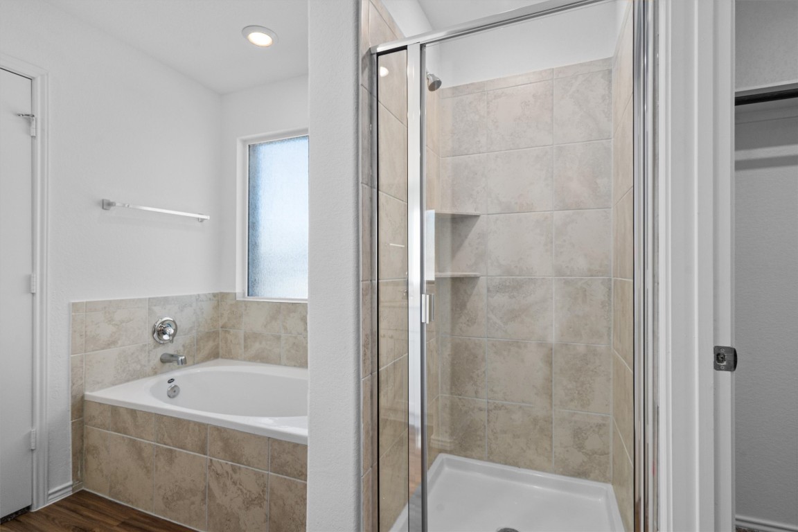 3213 Ancira Place Pflugerville, TX 78660 - Photo 16 of 30 a bathroom with a bathtub and a shower