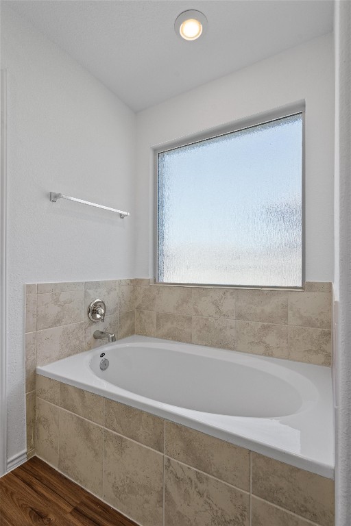 3213 Ancira Place Pflugerville, TX 78660 - Photo 17 of 30 a bathroom with a bathtub and a shower