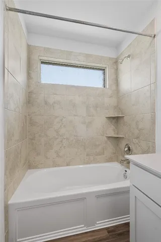 a bathroom with a bathtub and a shower