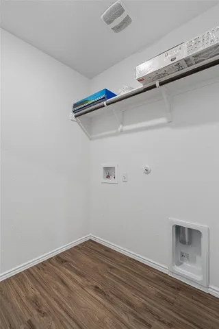 a view of a room with wooden floor