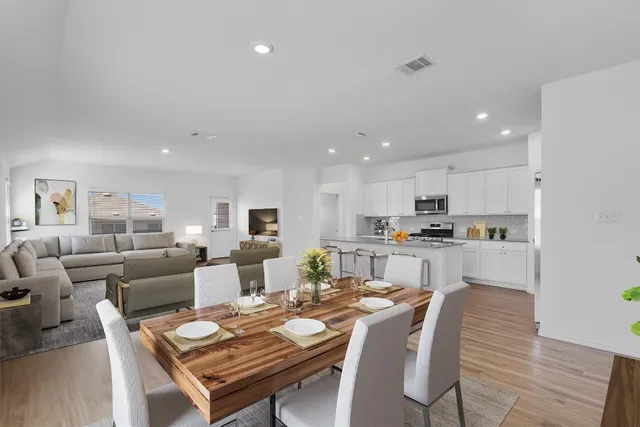 a living room with lots of furniture and kitchen view