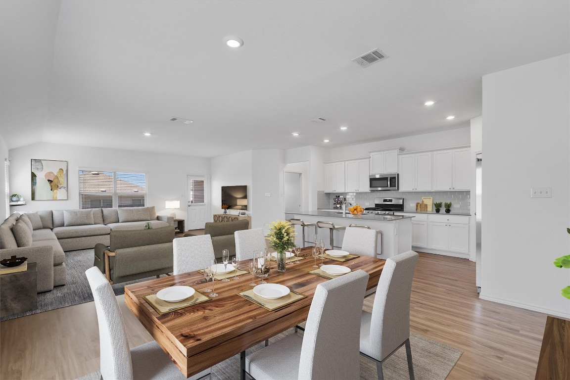 3213 Ancira Place Pflugerville, TX 78660 - Photo 3 of 30 a living room with lots of furniture and kitchen view