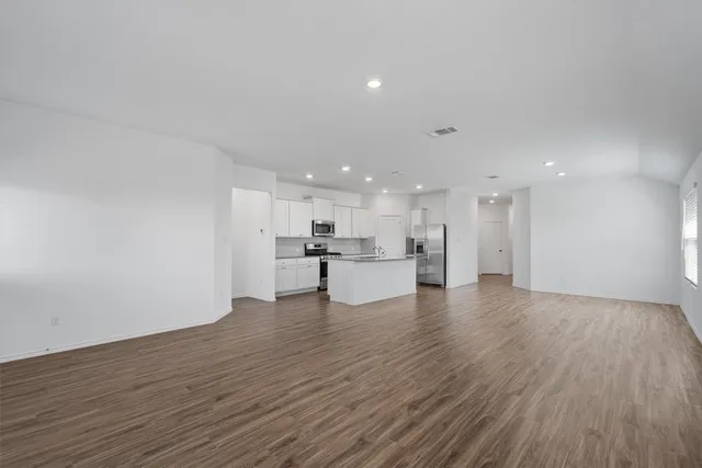 a view of kitchen dining table chairs microwave and cabinets