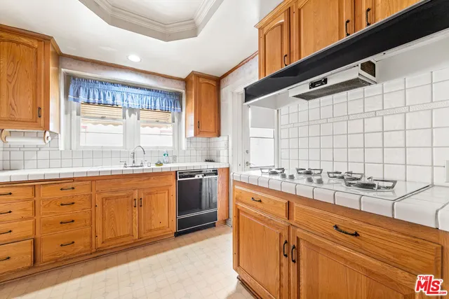 a kitchen with granite countertop a sink and cabinets