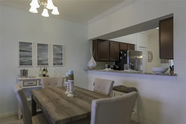 a living room with furniture a flat screen tv and kitchen view