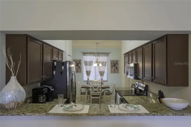 a kitchen with a refrigerator and a sink