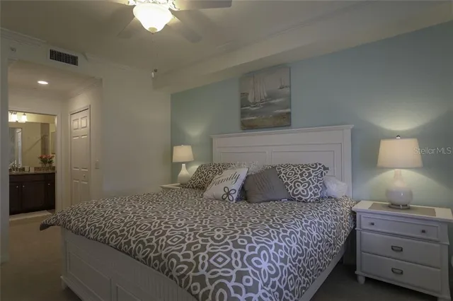 a bedroom with a large bed and a chandelier