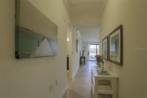 a hallway with a view of living room with furniture