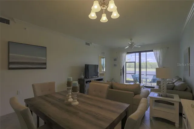 a living room with furniture a flat screen tv and a window