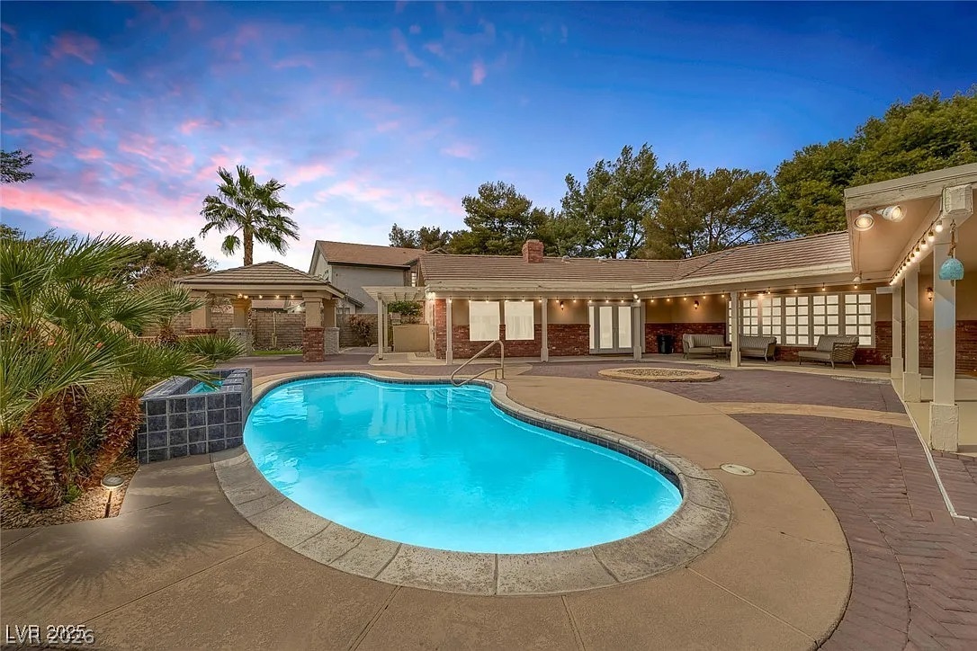 9 Quail Run Road Henderson, NV 89014 - Photo 40 of 57 An inviting backyard oasis offers a sparkling pool, spa, and covered patio for relaxed entertaining.