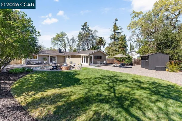 a view of a house with a tree in the background