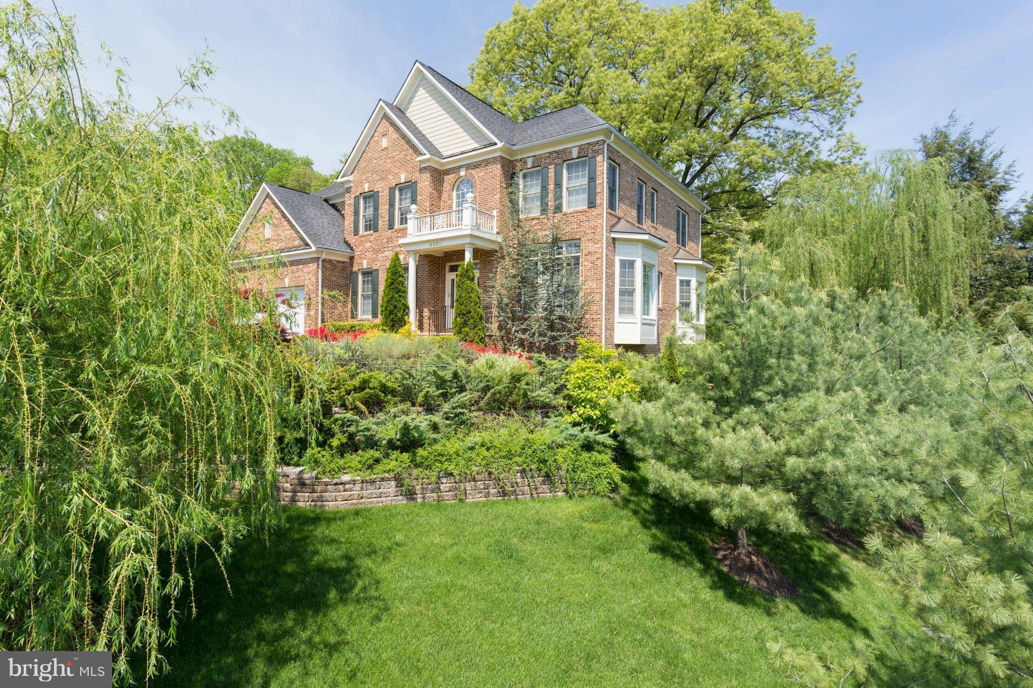 9208 Jones Mill Road Chevy Chase, MD 20815 - Photo 1 of 30 a front view of a house with a yard and trees