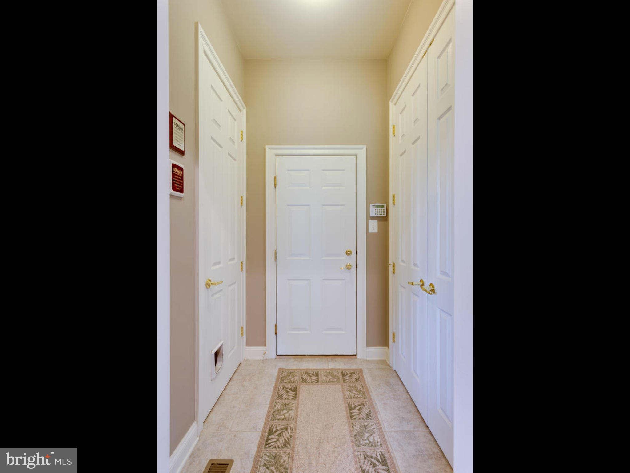 9208 Jones Mill Road Chevy Chase, MD 20815 - Photo 13 of 30 a view of a hallway with wooden floor and a bathroom
