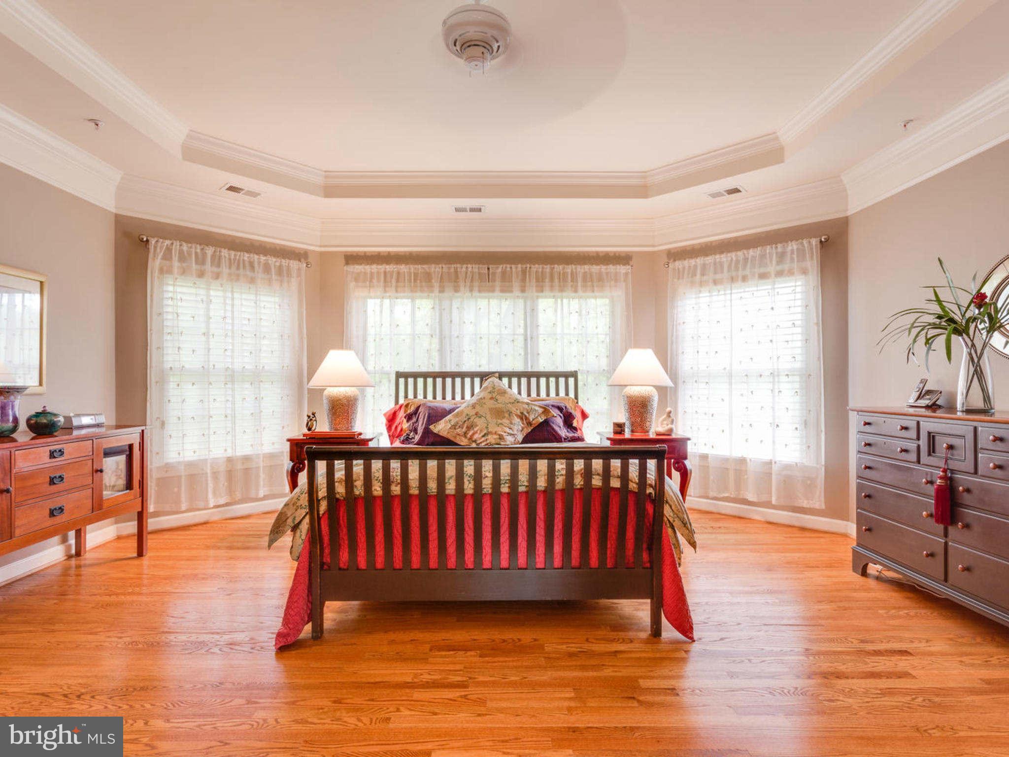 9208 Jones Mill Road Chevy Chase, MD 20815 - Photo 14 of 30 a bedroom with furniture window and wooden floor