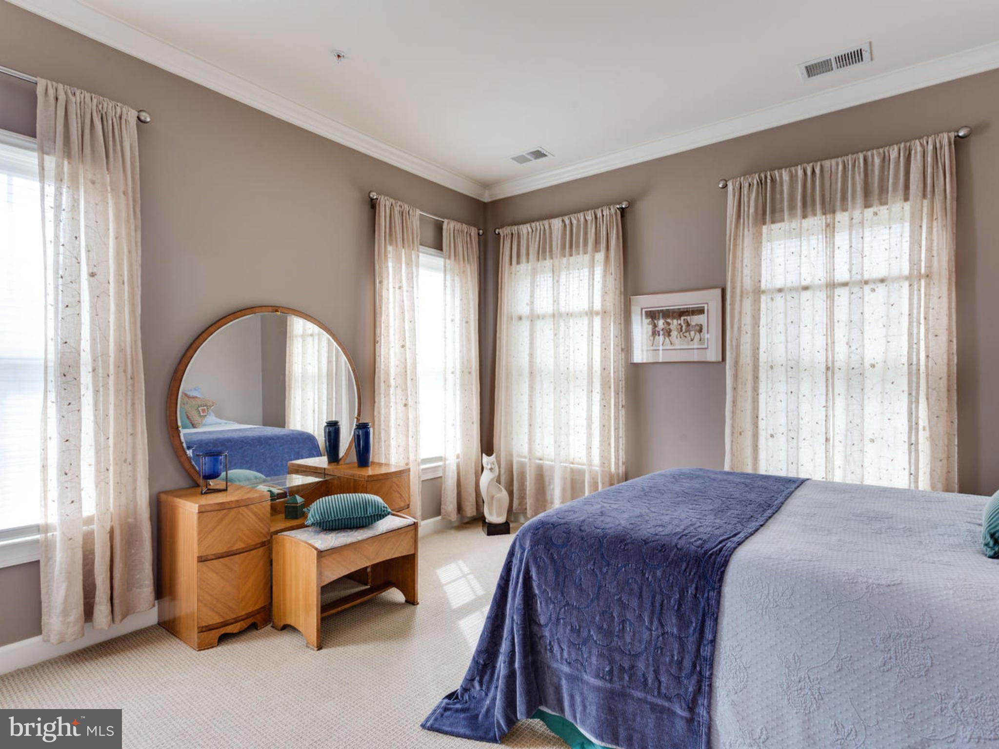 9208 Jones Mill Road Chevy Chase, MD 20815 - Photo 19 of 30 a spacious bedroom with a bed and a large window