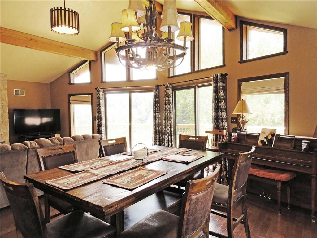 1127 Pine Run Road Apollo, PA 15613 - Photo 8 of 25 Open living room and dining room with hardwood floors, vaulted ceilings and a wall of windows overlooks the 2.47 acres