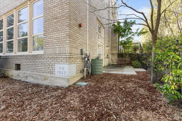 a view of a brick house with a yard