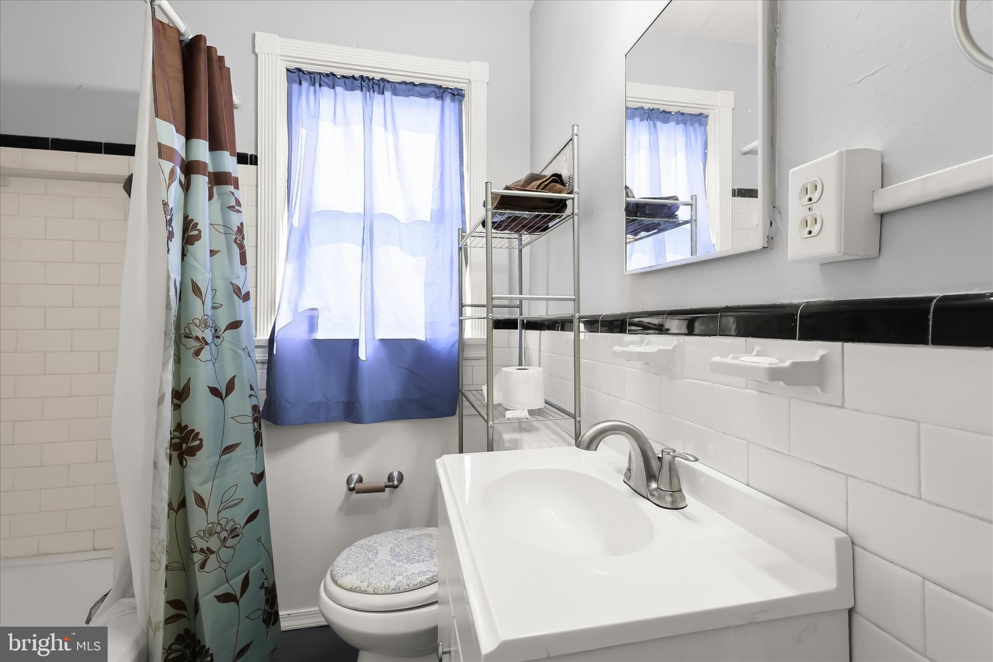 1504 North Linwood Avenue Baltimore, MD 21213 - Photo 20 of 29 a bathroom with a toilet a sink and a mirror