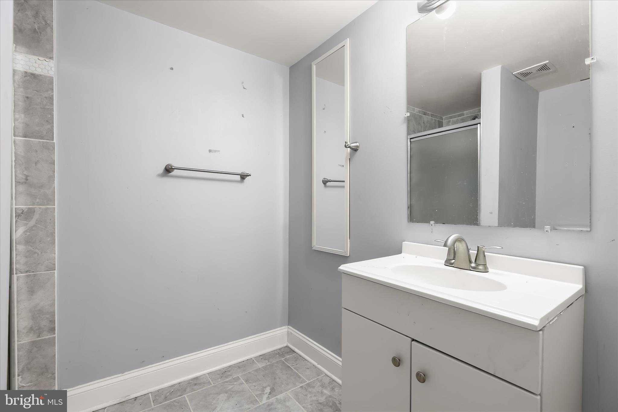 1504 North Linwood Avenue Baltimore, MD 21213 - Photo 25 of 29 a bathroom with a sink and a mirror