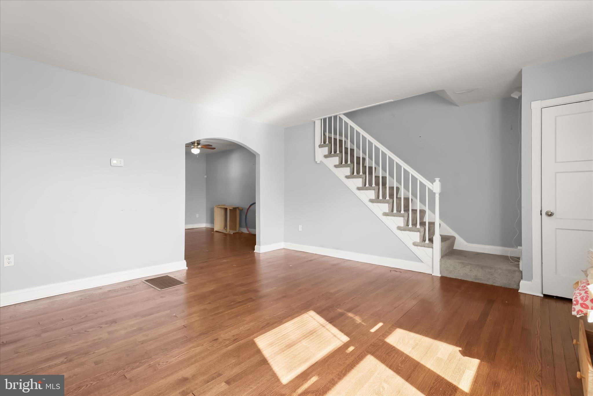1504 North Linwood Avenue Baltimore, MD 21213 - Photo 4 of 29 a view of a hallway with wooden floor and stairs