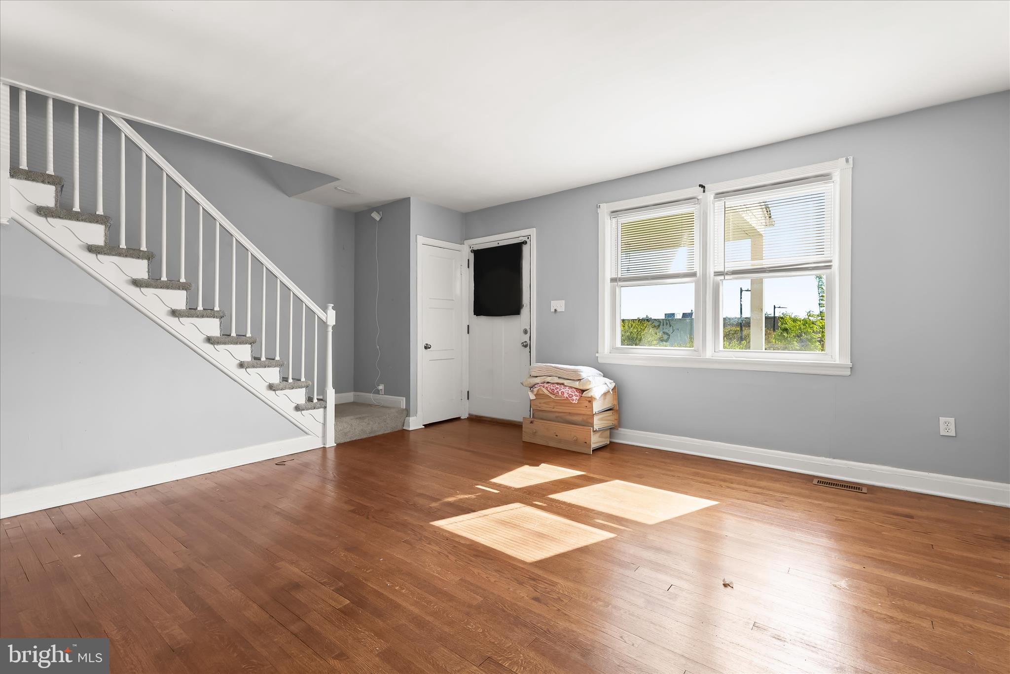 1504 North Linwood Avenue Baltimore, MD 21213 - Photo 5 of 29 a view of livingroom with hardwood floor and stairs