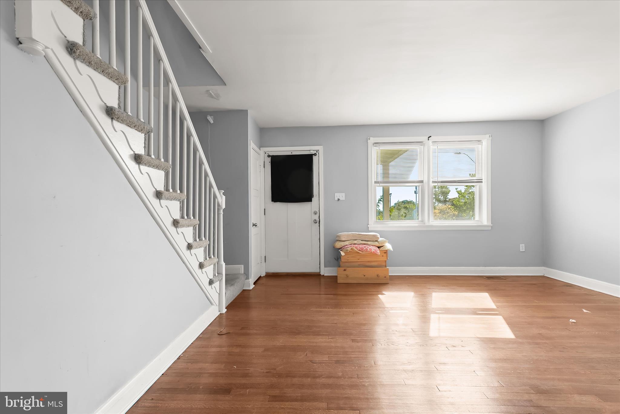1504 North Linwood Avenue Baltimore, MD 21213 - Photo 6 of 29 a view of an empty room with wooden floor and a window