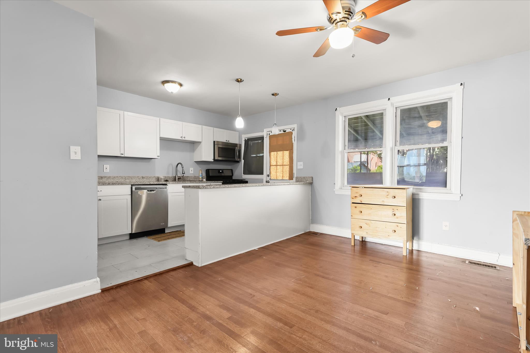 1504 North Linwood Avenue Baltimore, MD 21213 - Photo 8 of 29 a kitchen with stainless steel appliances kitchen island wooden cabinets and a stove