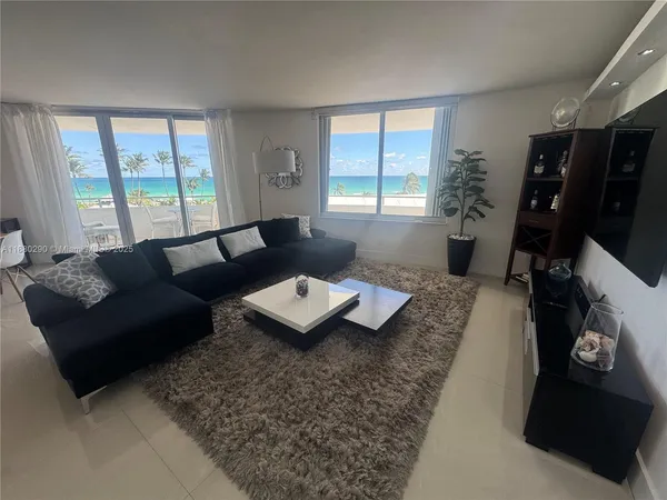 a bedroom with a large bed and a flat screen tv