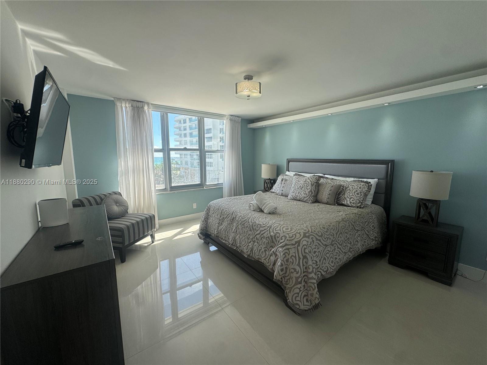 5161 Collins Avenue, Unit 514 Miami Beach, FL 33140 - Photo 12 of 34 a bedroom with a bed and a television
