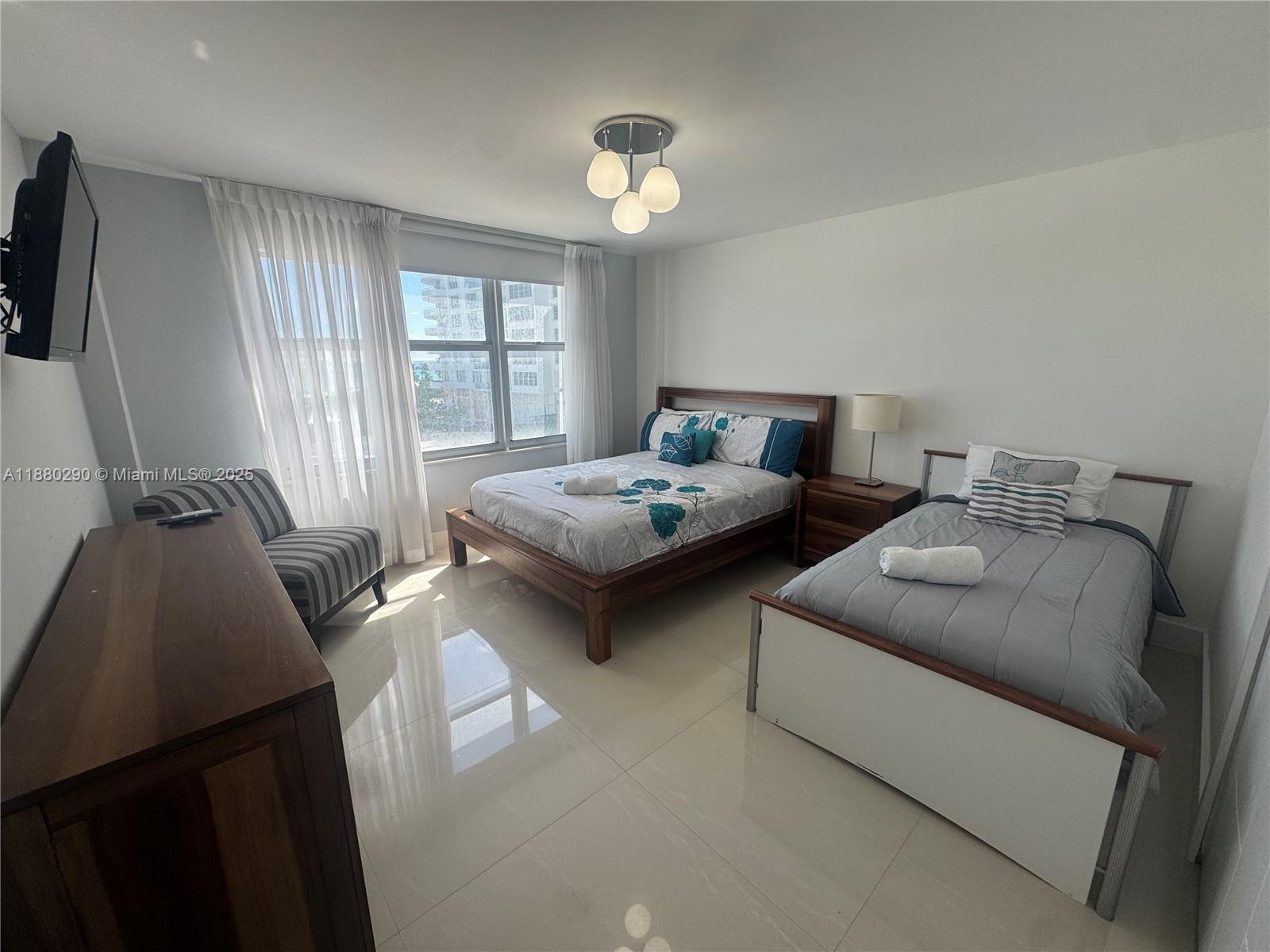 5161 Collins Avenue, Unit 514 Miami Beach, FL 33140 - Photo 17 of 34 a living room with furniture and a window