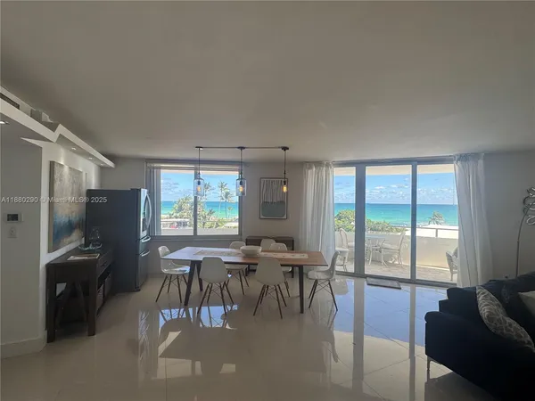 a kitchen with refrigerator and chairs