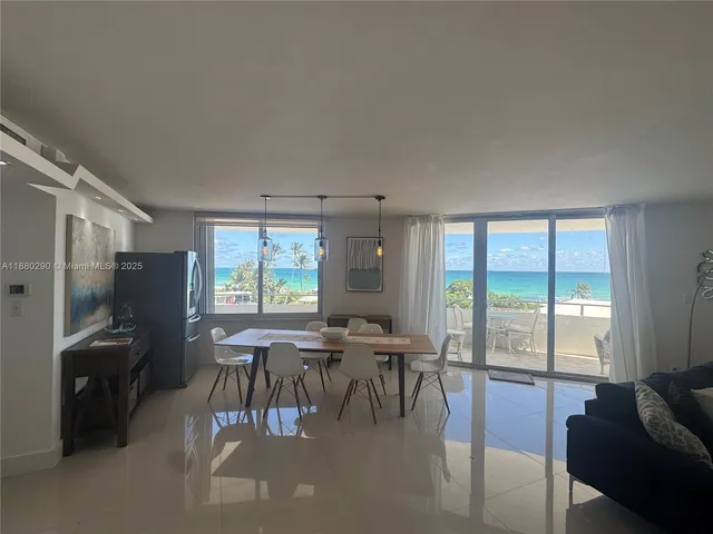 a kitchen with refrigerator and chairs