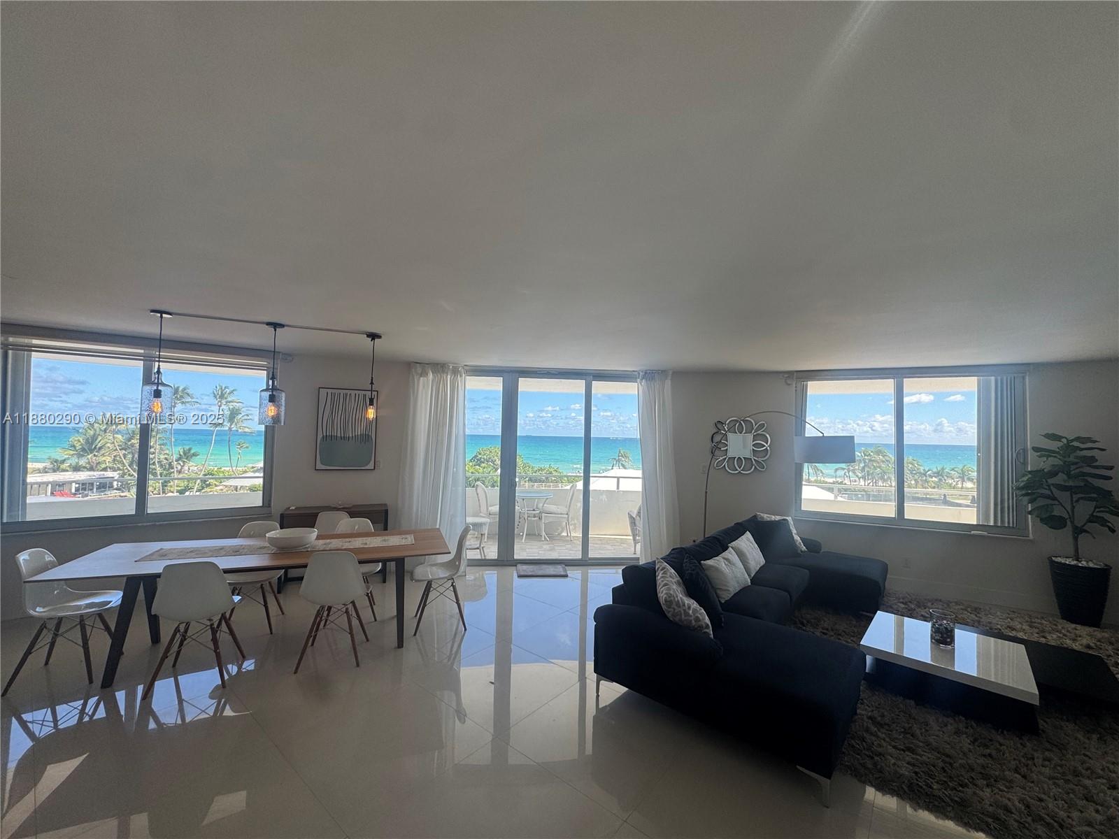 5161 Collins Avenue, Unit 514 Miami Beach, FL 33140 - Photo 9 of 34 a living room with furniture and a large window