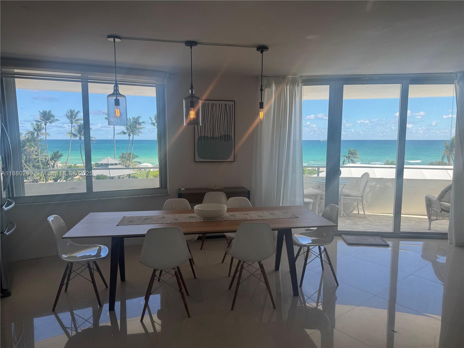 5161 Collins Avenue, Unit 514 Miami Beach, FL 33140 - Photo 10 of 34 a view of a dining room with furniture window and wooden floor