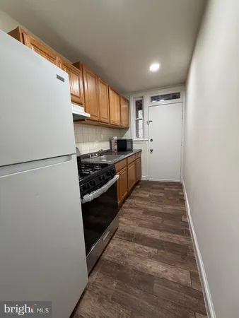 a kitchen with a refrigerator and a stove