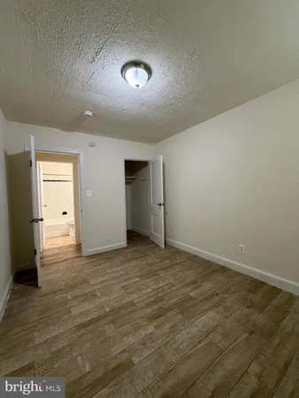 an empty room with closet and wooden door
