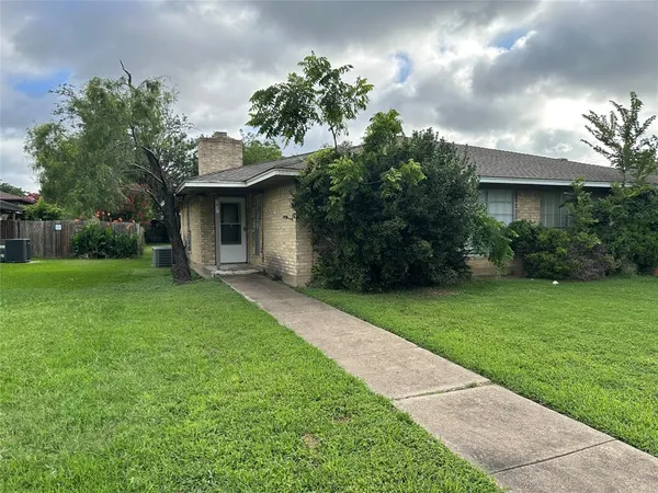 a view of a house with yard and a garden
