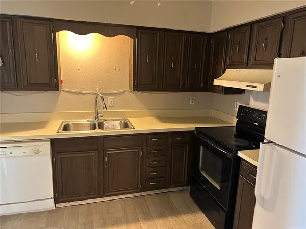 a kitchen with a sink and cabinets