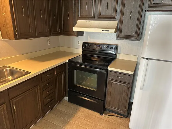a kitchen with granite countertop cabinets and steel stainless steel appliances