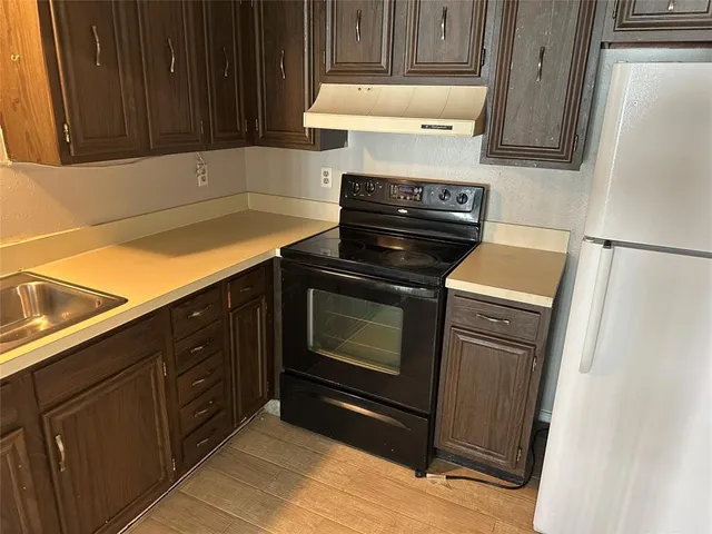 a kitchen with granite countertop cabinets and steel stainless steel appliances